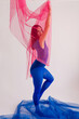 © Tania Cervian/Stocksy - Confident slender woman in blue tights covered with pink fabric
