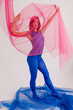 © Tania Cervian/Stocksy - Slim lady wearing blue bodysuit and tights stretching body