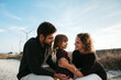 © Irina Polonina/Stocksy - Family Bonding Near Wind Turbines at Dusk
