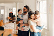 © Lea Jones/Stocksy - portrait of smiling and happy  family in dining room .