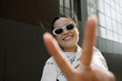 © Azamat Mukanov/Stocksy - Smiling Asian Woman in Sunglasses