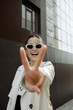 © Azamat Mukanov/Stocksy - Smiling Asian Woman in Sunglasses