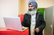 © Hernandez & Sorokina/Stocksy - Indian Businessman Using Laptop Indoors