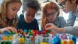 © Justlight - A group of kids work together to solve a puzzle made of building blocks representing the composition of different composite particles made of leptons.
