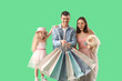 © Pixel-Shot - Happy family with dog and shopping bags on green background