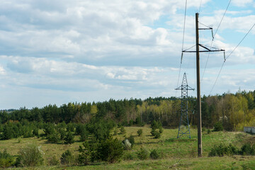 Wall Mural - Power lines running through the forest. The support of an overhead power line. Natural landscape and technological progress.