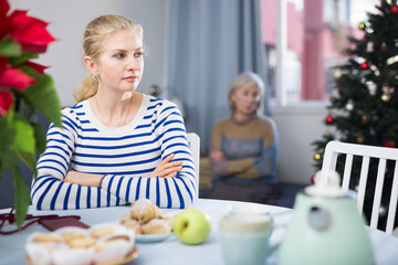 Wall Mural - Portrait of an offended adult daughter at her elderly mother, who quarreled with her before Christmas