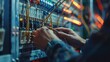 © printartist - A male electrician works in a switchboard to connect electric wires in the system. Electrician engineer test the electrical installation and power line current in an electrical system control cabinet