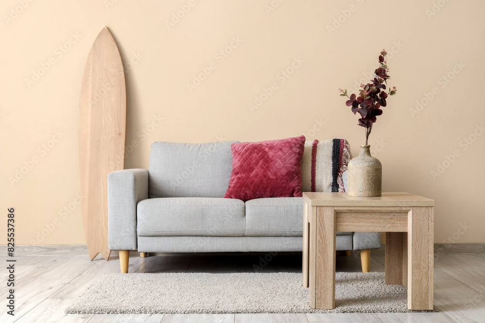 Surfboard, sofa and coffee table in living room