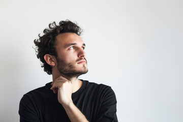 Canvas Print - A thoughtful man with a hand on his chin, standing alone against a plain white backdrop, devoid of surroundings. Concept of contemplation and reflection. Generative Ai.