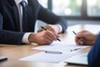 © Gorilla Studio - two men are sitting at a desk with a pen and a pen in front of them