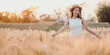 © Satori Studio - A woman is standing in a field of tall golden wheat. She is wearing a white dress and a straw hat. The scene is peaceful and serene, with the sun shining brightly overhead
