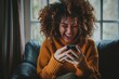 © Nadia Do - A young woman with curly hair holding a smartphone and laughing looking at the screen