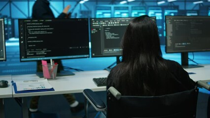 Poster - woman with impairment in server farm looking over hardware parameters on clipboard files. wheelchair