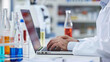 © Narongrit - Scientist recording data on a laptop in a laboratory
