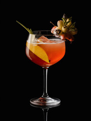 Wall Mural - a cocktail in a glass with fruit on a black background

