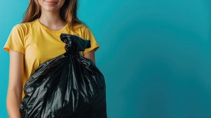 Wall Mural - woman holding black garbage bag isolated on blue background, close up, banner with copy space area, stock photo photography, copy spa