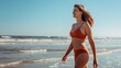 © Daria Lukoiko - A slender happy woman in a red swimsuit walks cheerfully along the sea coast and smiles at the upcoming vacation. Young girl relaxing vacation at sea