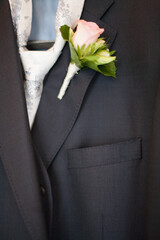 Elegant suit jacket with white rose boutonniere, perfect for weddings and formal events ideal for groom or attendee
