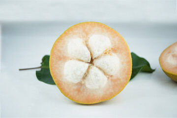 Wall Mural - santol cut that can see seed on white background.
