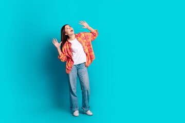 Poster - Full size photo of nice young girl look up empty space wear plaid shirt isolated on teal color background