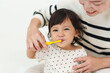 © geargodz - mother brushing her daughters teeth. happy baby with tooth brush