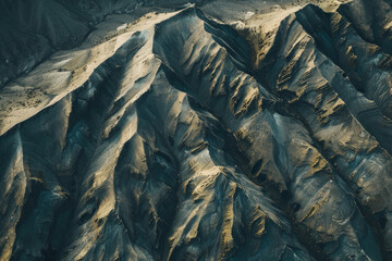 Wall Mural - Minimalist aerial view of mountain ridges, showcasing sharp lines and natural patterns in the terrain. 