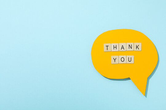 Thank you, the word is laid out from letters on a blue background.