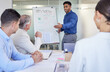 © peopleimages.com - Presentation, businessman and whiteboard for team solution, question or brainstorming in meeting. Board, leader and planning finance strategy, data and economist coaching on graph in conference room
