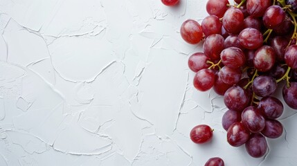 Wall Mural - Fresh Ripe Juicy Red Grapes Arranged on White Surface with Space for Text