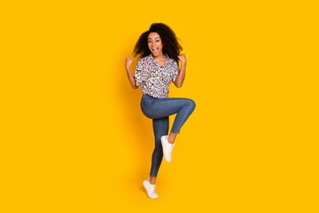 Wall Mural - Full length photo of lovely young lady winning raise fists dressed stylish leopard print garment isolated on yellow color background