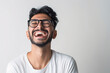 © SITI - Cheerful Middle Eastern Man Laughing in White T-Shirt with Glasses