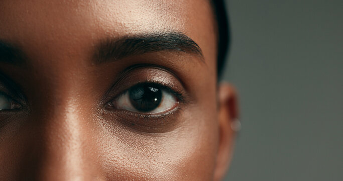 eye, beauty and skincare with a woman on a gray background in studio closeup for cosmetics. face, vi