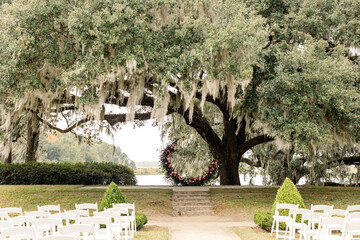 Wall Mural - Outdoor wedding ceremony setup under oak tree with floral arch