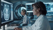 © Sadia - Female in lab coat using computer with mri images on screen
