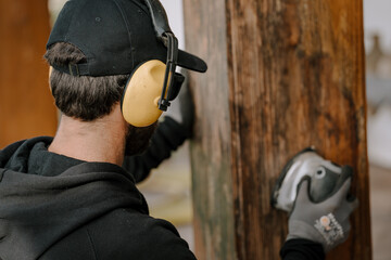 Man cutting a tree with a circular saw