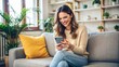 © Kanchana - young caucasian woman smiling happy sitting on floor with a smartphone at home using a tablet pc