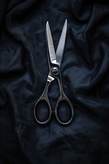 Poster - Pair of scissors on a black cloth, suitable for various projects