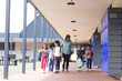 © WavebreakMediaMicro - In school, diverse group of students walking with their teacher outdoors