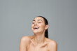 © LIGHTFIELD STUDIOS - A happy woman, laughing joyfully.