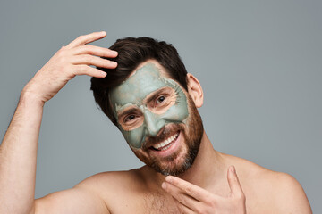 Wall Mural - A man with a facial mask on his face, standing confidently.