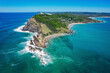 © AmazingAerialAgency - Aerial view of beautiful sandy beach and blue ocean at Cape Byron State Conservation Area, Byron Bay, Australia.