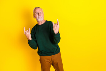 Poster - Photo portrait of handsome retired man enjoy rock music dancing wear trendy green outfit isolated on yellow color background