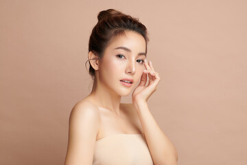 Beautiful young asian woman with clean fresh skin on beige background, Face care, Facial treatment, Cosmetology, beauty and spa, Asian women portrait.