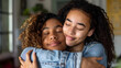 © john - Happy biracial teenage daughter with eyes closed hugging mother from behind at home