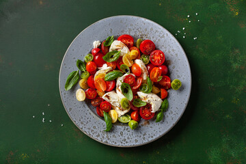 Wall Mural - healthy colorful tomato mozzarella basil salad with balsamic vinegar dressing