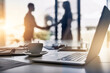 © peopleimages.com - Handshake, laptop and business people silhouette with lens flare, crm and thank you with greeting and welcome of staff. Tech, cup and desk at a company in the morning at meeting with computer and b2b