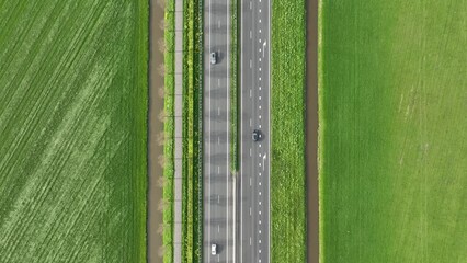 Wall Mural - drone view of a road in the middle of a field. landscape from a drone. road and transport. car traff