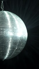 Sticker - A mirrored disco ball is spinning at a party. Silvery rays of light are reflected from it in the smoke.