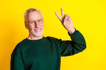 Poster - Photo portrait of handsome retired man show v-sign wear trendy green outfit isolated on yellow color background